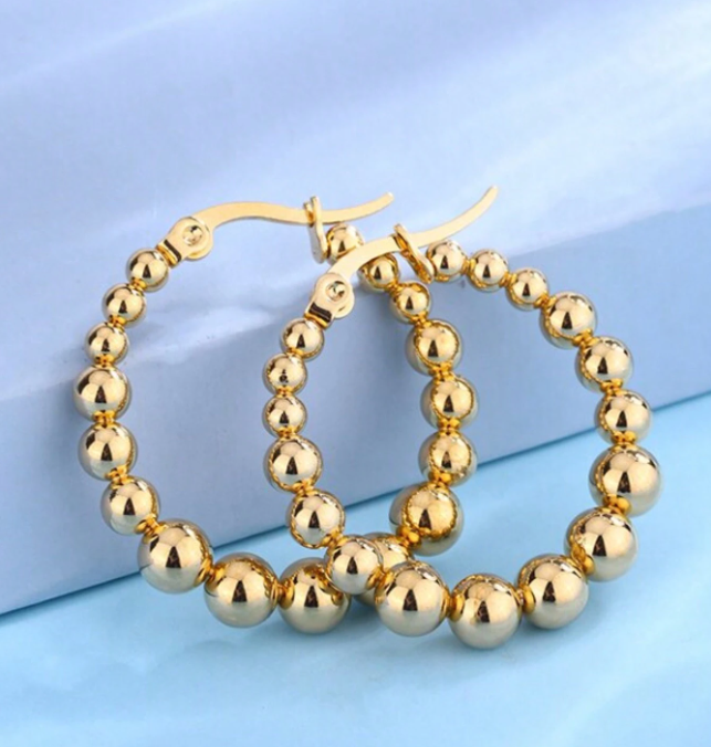 ARGOLLAS DE ACERO QUIRÚRGICO BOLITAS DORADAS.